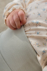 Back view of baby in Avauma Aileen Baby Leggings - Powder Mint, elastic high-waist design, snug fit Back view of baby in Avauma Aileen Baby Leggings - Powder Mint, elastic high-waist design, snug fit