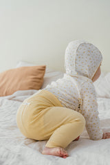 Back view of baby in Avauma Aileen Baby Leggings - Spring Lemon, ribbed texture, elastic high waist Back view of baby in Avauma Aileen Baby Leggings - Spring Lemon, ribbed texture, elastic high waist