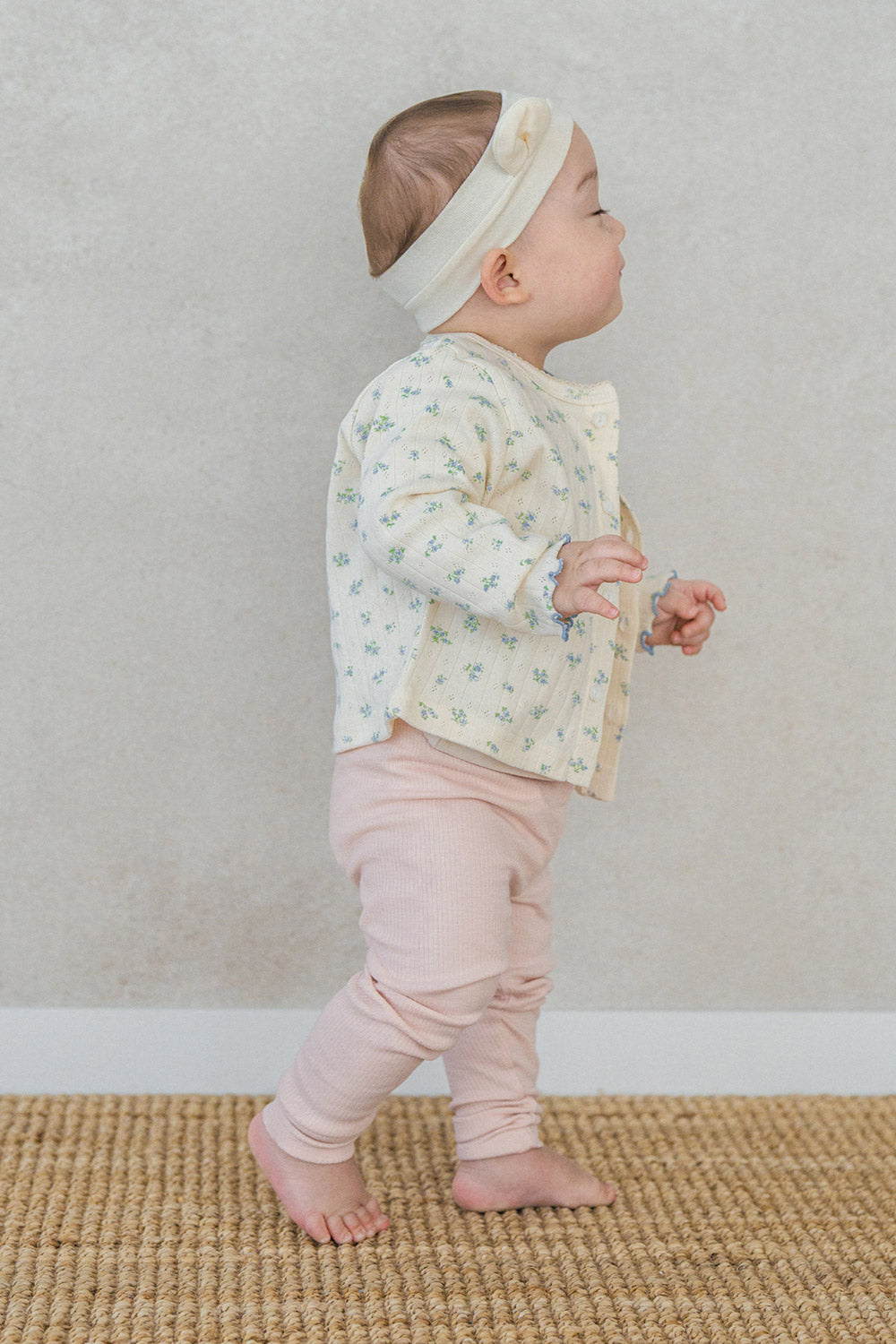 Baby wearing Avauma Aileen Bloom Cardigan with bear ear headband, cute and comfortable floral knit cardigan for infants. Baby wearing Avauma Aileen Bloom Cardigan with bear ear headband, cute and comfortable floral knit cardigan for infants.