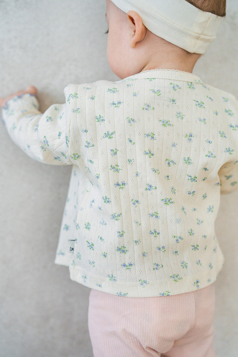 Back view of Avauma Aileen Bloom Cardigan, soft cotton ribbed fabric with delicate floral print, breathable and lightweight. Back view of Avauma Aileen Bloom Cardigan, soft cotton ribbed fabric with delicate floral print, breathable and lightweight.