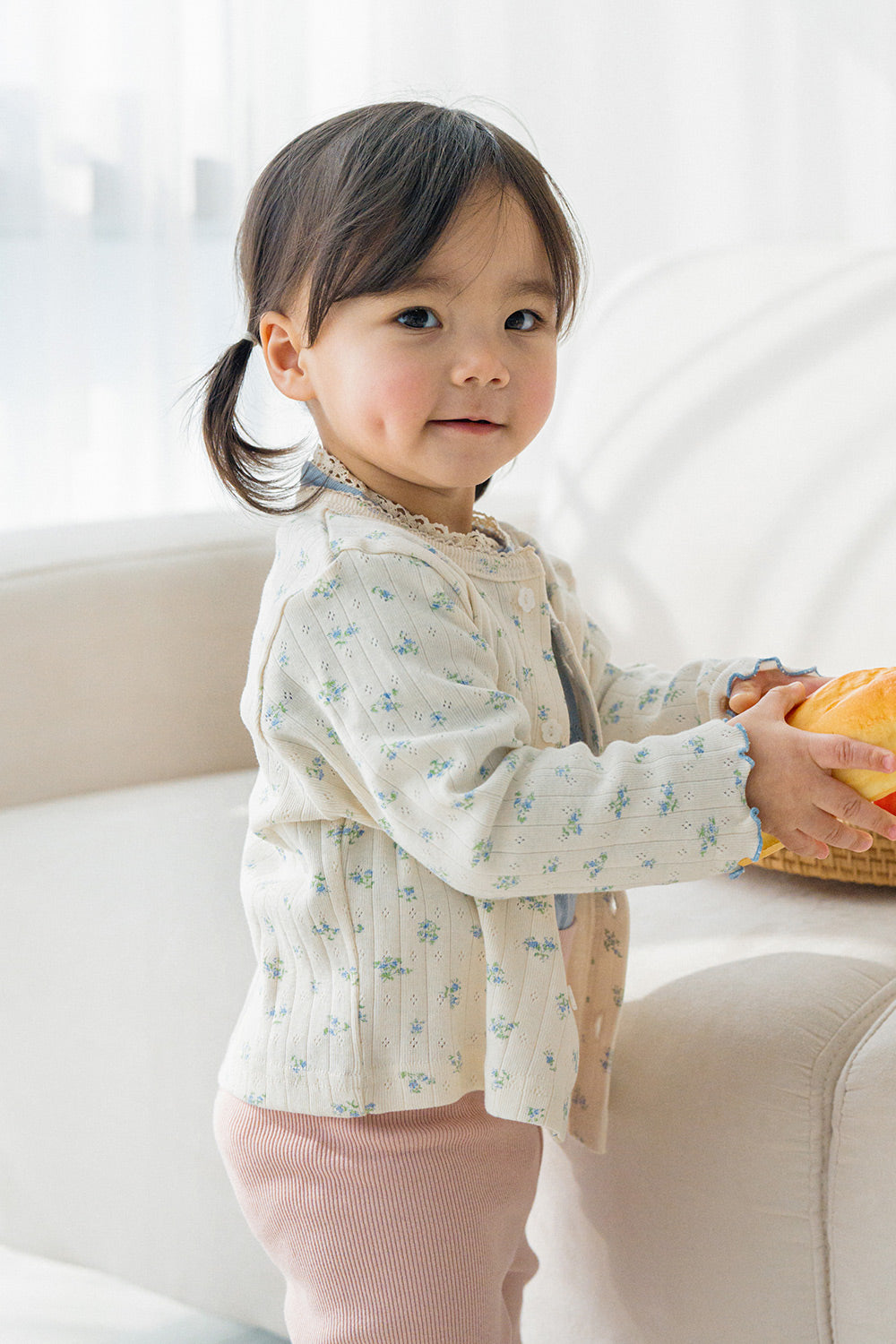 Close-up of Avauma Aileen Bloom Cardigan in Milk Flower, delicate floral knit baby cardigan, cozy and stylish for toddlers. Close-up of Avauma Aileen Bloom Cardigan in Milk Flower, delicate floral knit baby cardigan, cozy and stylish for toddlers.