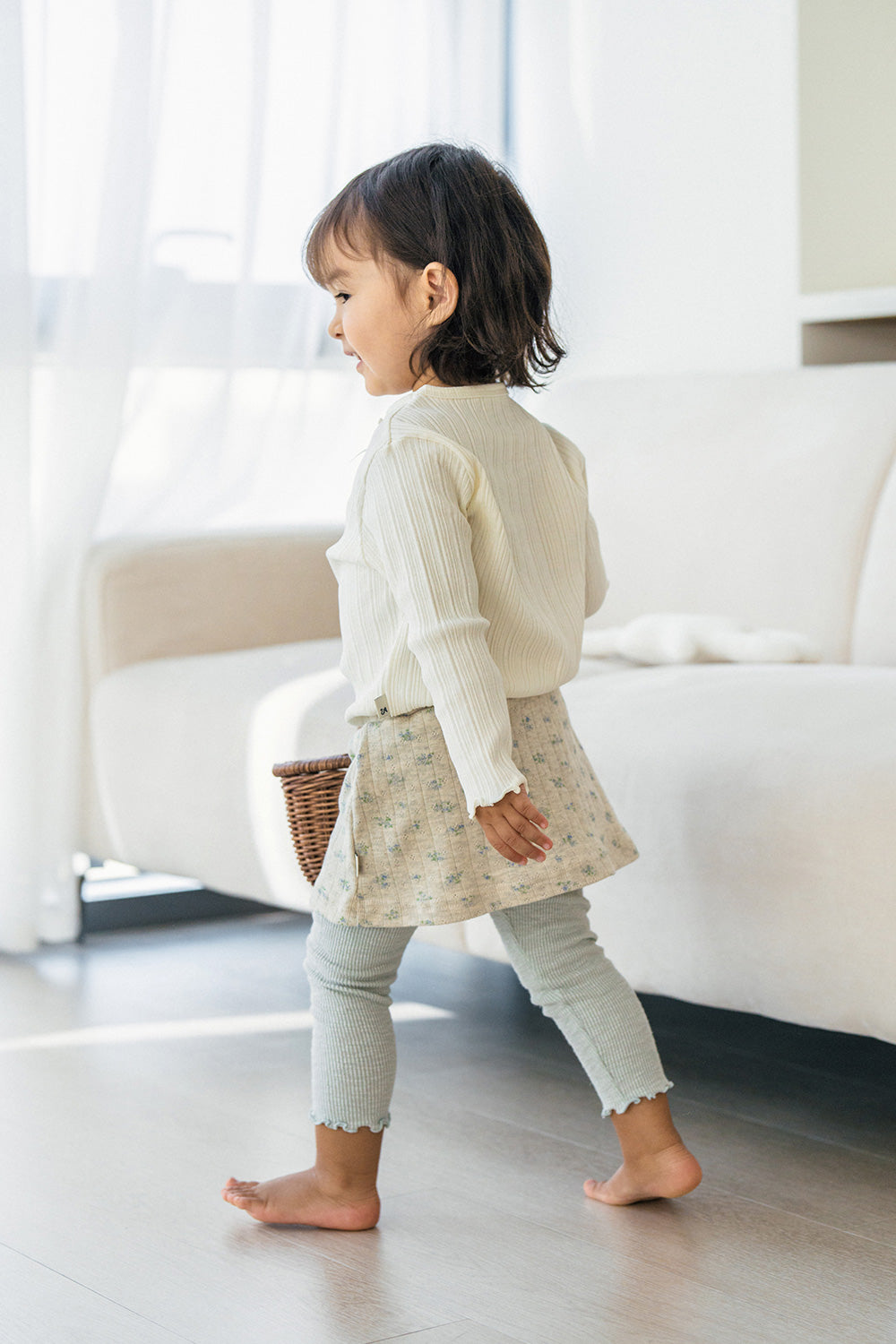 Back view of Avauma Chloe Ribbon T-shirt in Cotton Cream, showing soft ribbed fabric and frilled edges Back view of Avauma Chloe Ribbon T-shirt in Cotton Cream, showing soft ribbed fabric and frilled edges
