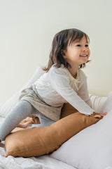 Little girl wearing Avauma Chloe Ribbon T-shirt in Cotton Cream, styled with a floral skirt and ribbed leggings. Little girl wearing Avauma Chloe Ribbon T-shirt in Cotton Cream, styled with a floral skirt and ribbed leggings.