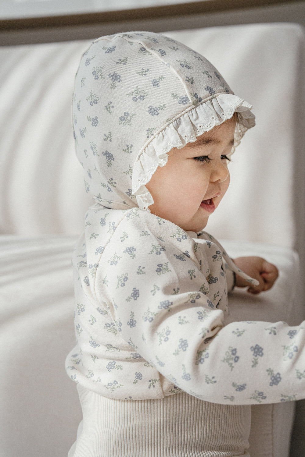 Side profile of a baby in the Avauma Cream Bodysuit (Spring Forest pattern) – showcasing the snug fit, breathable cotton fabric, and sweet floral motif ideal for newborn comfort. Side profile of a baby in the Avauma Cream Bodysuit (Spring Forest pattern) – showcasing the snug fit, breathable cotton fabric, and sweet floral motif ideal for newborn comfort.