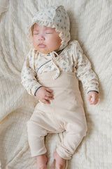 Baby sleeping in the Avauma Cream Bodysuit (Spring Forest print) – showing the breathable fabric, gentle wrap closure, and soothing floral pattern ideal for newborn rest. Baby sleeping in the Avauma Cream Bodysuit (Spring Forest print) – showing the breathable fabric, gentle wrap closure, and soothing floral pattern ideal for newborn rest.