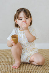 AVAUMA toddler girl smiling in lemon butter floral summer pajama set AVAUMA toddler girl smiling in lemon butter floral summer pajama set