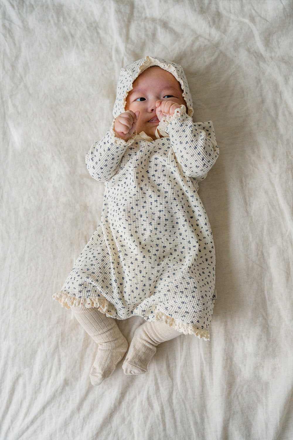 Baby wearing the Olive Rose bodysuit and bonnet – showcasing delicate lace details around the neckline and cuffs for a soft, elegant look. Baby wearing the Olive Rose bodysuit and bonnet – showcasing delicate lace details around the neckline and cuffs for a soft, elegant look.