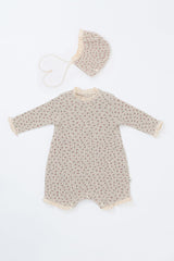 Front view of the Lumiere Bodysuit in Mellow Rose – featuring delicate lace trim and a subtle rose print for babies. Front view of the Lumiere Bodysuit in Mellow Rose – featuring delicate lace trim and a subtle rose print for babies.