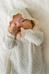 Baby lying down in the Lumiere Classic Blossom Bodysuit – showing a comfortable fit and natural freedom of movement Baby lying down in the Lumiere Classic Blossom Bodysuit – showing a comfortable fit and natural freedom of movement