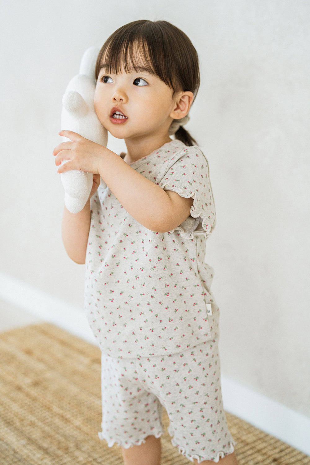 Toddler wearing Avauma Mellow Days Set in Berry Cream, holding a white plush bunny to her cheek Toddler wearing Avauma Mellow Days Set in Berry Cream, holding a white plush bunny to her cheek
