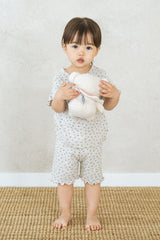 Toddler standing and holding a teddy bear, wearing the Avauma Mellow Days Set in Berry Cream Toddler standing and holding a teddy bear, wearing the Avauma Mellow Days Set in Berry Cream