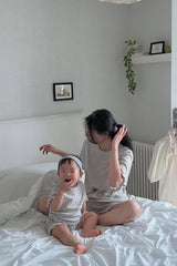 Mom and baby relaxing on bed in AVAUMA Berry Cream matching pajama set
Mom and baby relaxing on bed in AVAUMA Berry Cream matching pajama set