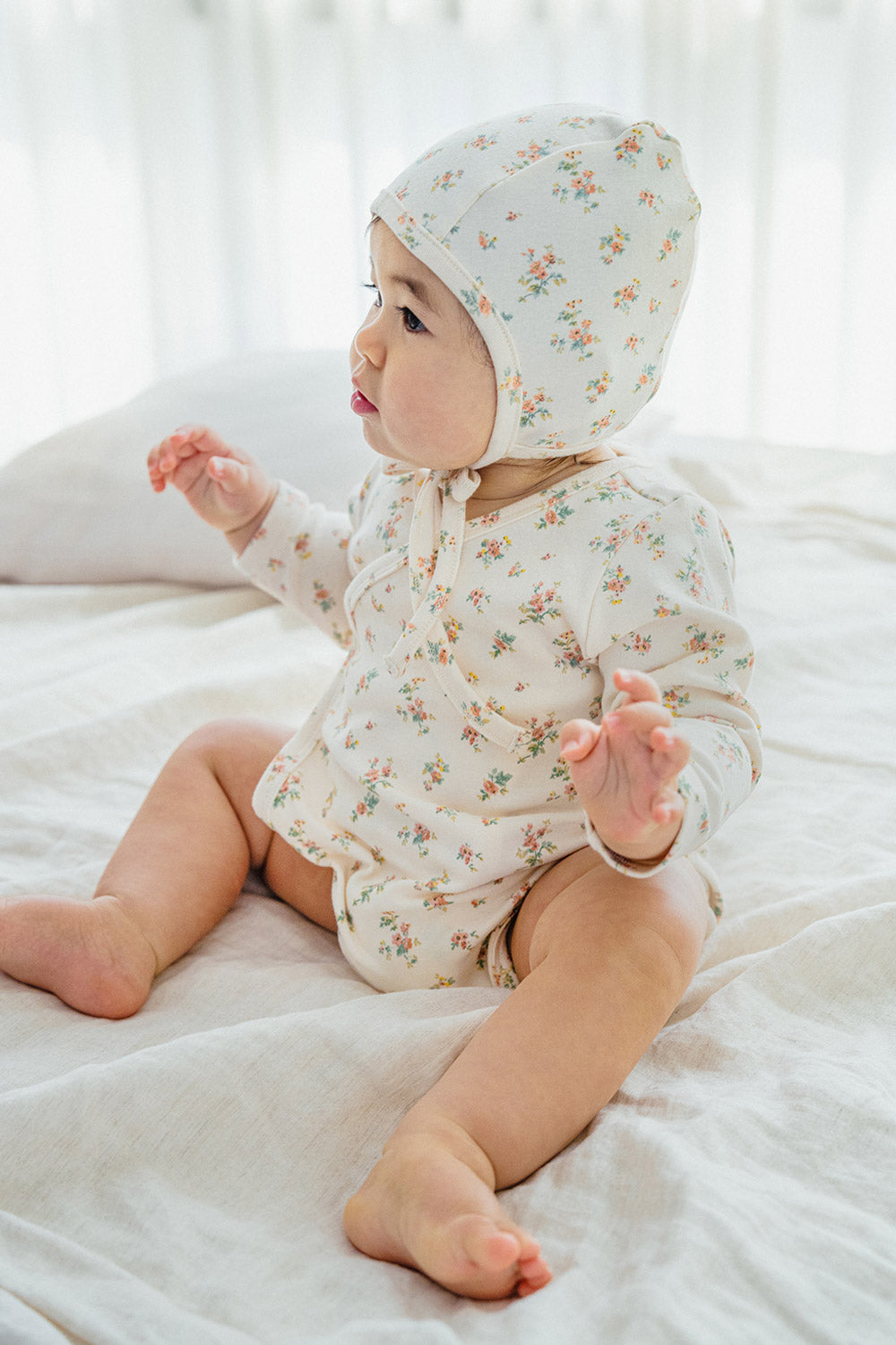Side view of the Cream Floral bodysuit – showcasing the wrap-style detail for a comfortable fit and easy movement Side view of the Cream Floral bodysuit – showcasing the wrap-style detail for a comfortable fit and easy movement