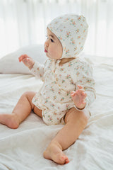 Side view of the Cream Floral bodysuit – showcasing the wrap-style detail for a comfortable fit and easy movement Side view of the Cream Floral bodysuit – showcasing the wrap-style detail for a comfortable fit and easy movement