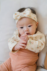 Baby wearing the Cream Floral bodysuit with a matching headband – a sweet floral pattern perfect for everyday outfits  Baby wearing the Cream Floral bodysuit with a matching headband – a sweet floral pattern perfect for everyday outfits