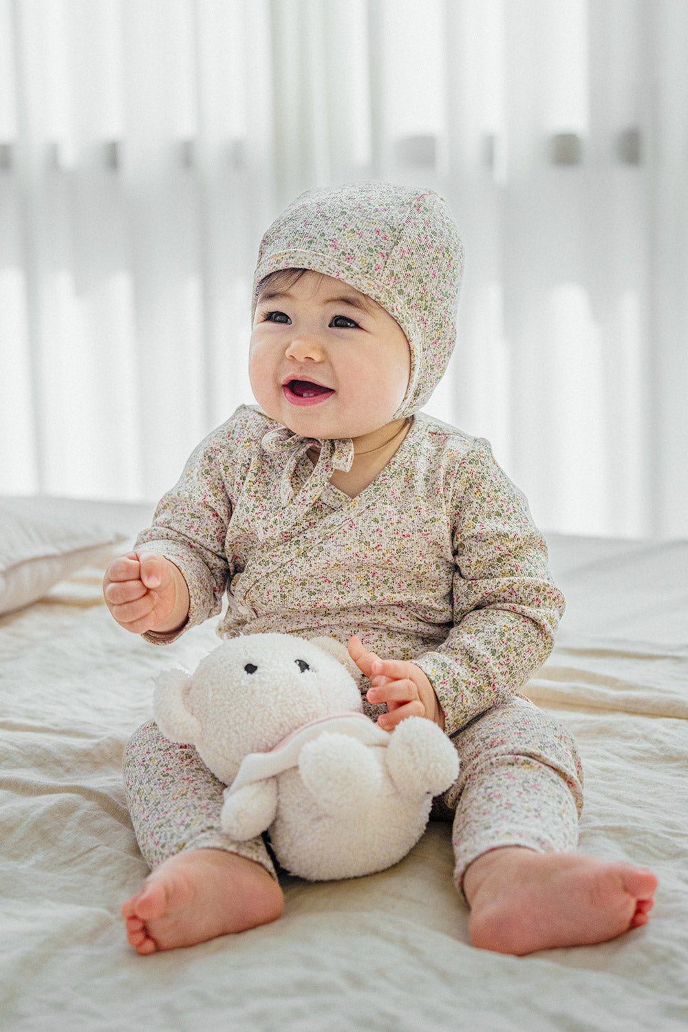 Selina Babysuit Iris lifestyle image – featuring an adorable baby wearing the iris-toned bodysuit perfect for everyday play and rest  Selina Babysuit Iris lifestyle image – featuring an adorable baby wearing the iris-toned bodysuit perfect for everyday play and rest