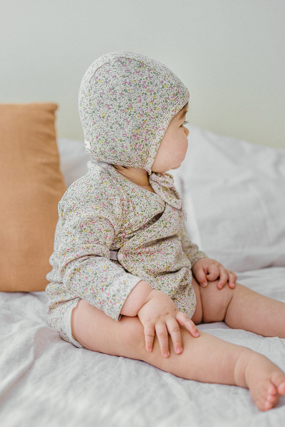 Selina Babysuit Iris side view – showcasing an elegant silhouette and breathable fabric designed for infant comfort Selina Babysuit Iris side view – showcasing an elegant silhouette and breathable fabric designed for infant comfort