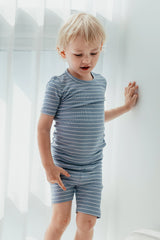 AVAUMA Flutter Short Sleeve Set Mono Beige + Dark Blue Stripe Pattern The passage emphasizes the breathability of the pajamas, making them perfect for keeping cool and comfortable, especially on hot days. The fabric is designed to provide a refreshing and airy feel, ensuring that children stay comfortable even in hot weather.