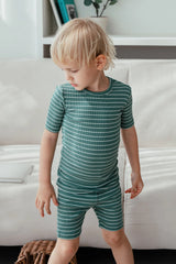AVAUMA Flutter Short Sleeve Set Olive Green + Dark Blue Stripe Pattern The passage emphasizes the breathability of the pajamas, making them perfect for keeping cool and comfortable, especially on hot days. The fabric is designed to provide a refreshing and airy feel, ensuring that children stay comfortable even in hot weather.