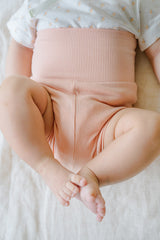 Close-up of newborn baby wearing Avauma Baby Hug Setup Peach Blossom. Soft pink infant clothing detail, comfortable baby wear. Close-up of newborn baby wearing Avauma Baby Hug Setup Peach Blossom. Soft pink infant clothing detail, comfortable baby wear.