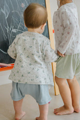Two toddlers wearing Avauma tank sets – blue picot and sage color variations shown from behind
Two toddlers wearing Avauma tank sets – blue picot and sage color variations shown from behind