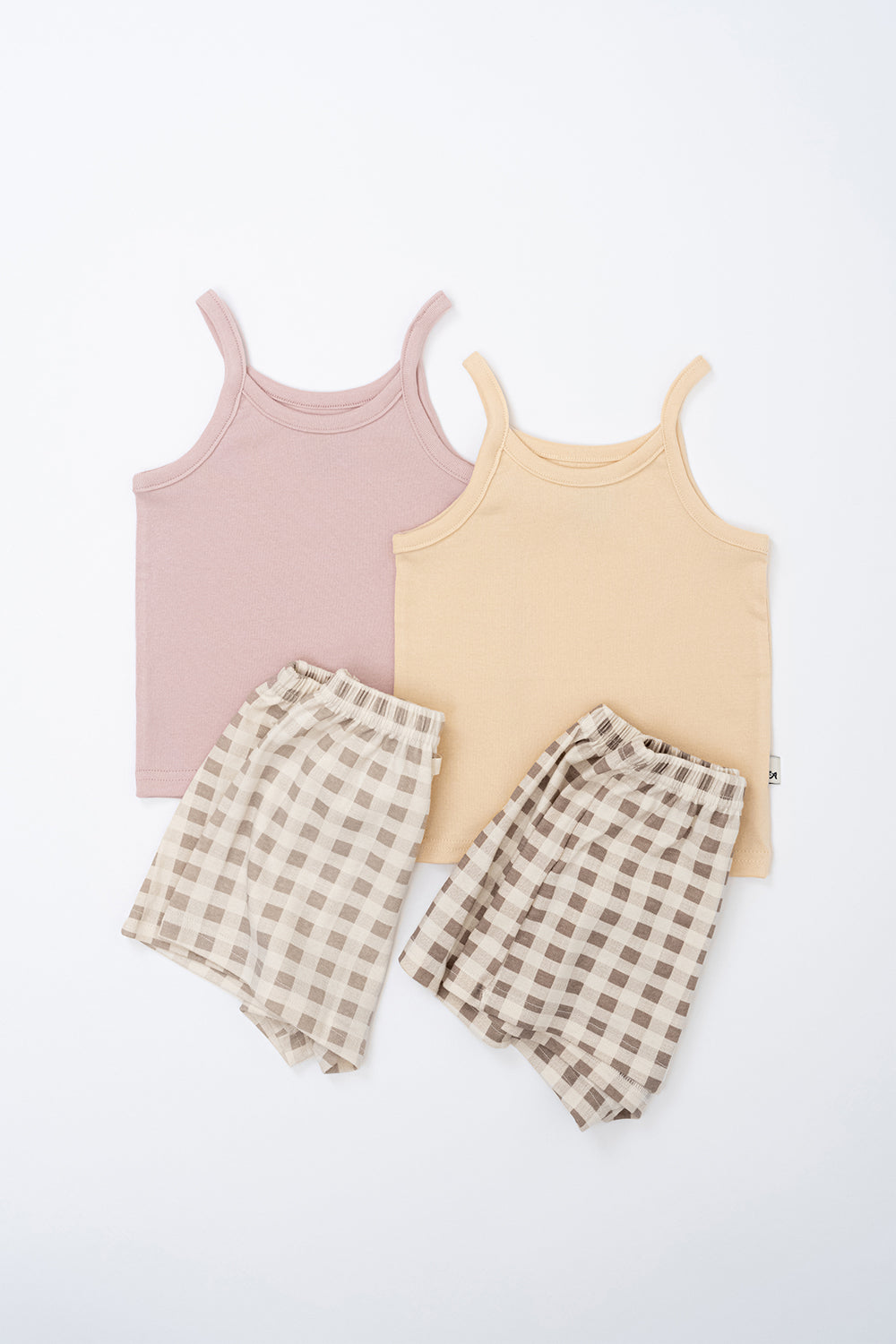 Flat lay of Avauma butter and pink check tank top sets – soft cotton sleeveless tops with matching gingham shorts
Flat lay of Avauma butter and pink check tank top sets – soft cotton sleeveless tops with matching gingham shorts