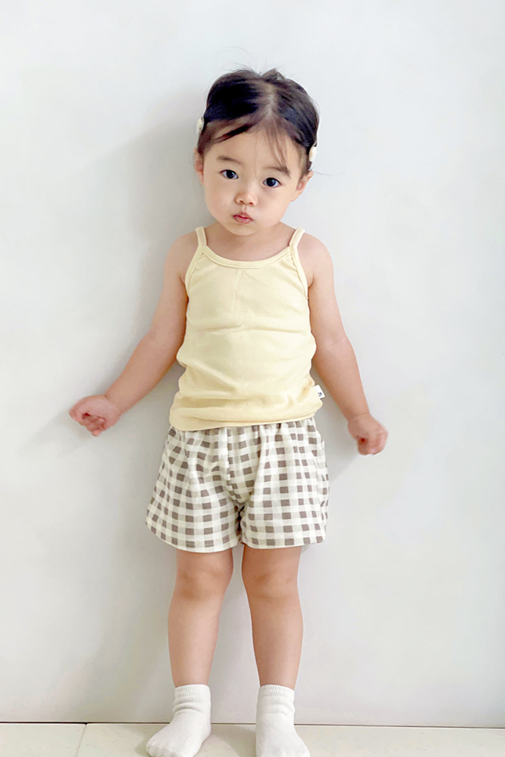 Toddler in Avauma butter check tank top set – light yellow sleeveless top with beige gingham shorts
Toddler in Avauma butter check tank top set – light yellow sleeveless top with beige gingham shorts