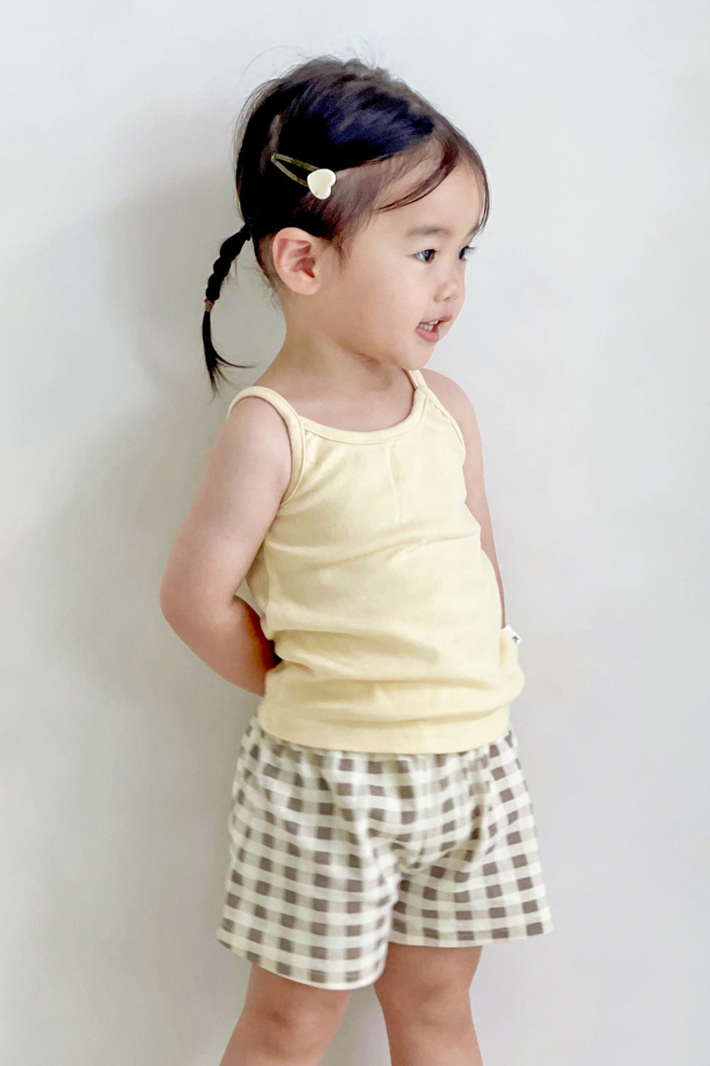 Side view of girl wearing Avauma butter tank top set – cozy summer outfit with check shorts
Side view of girl wearing Avauma butter tank top set – cozy summer outfit with check shorts
