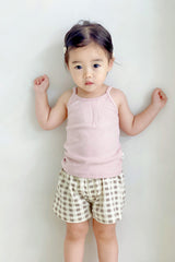 Boy in Avauma pink tank top with beige gingham shorts – simple and airy sleeveless outfit
Boy in Avauma pink tank top with beige gingham shorts – simple and airy sleeveless outfit