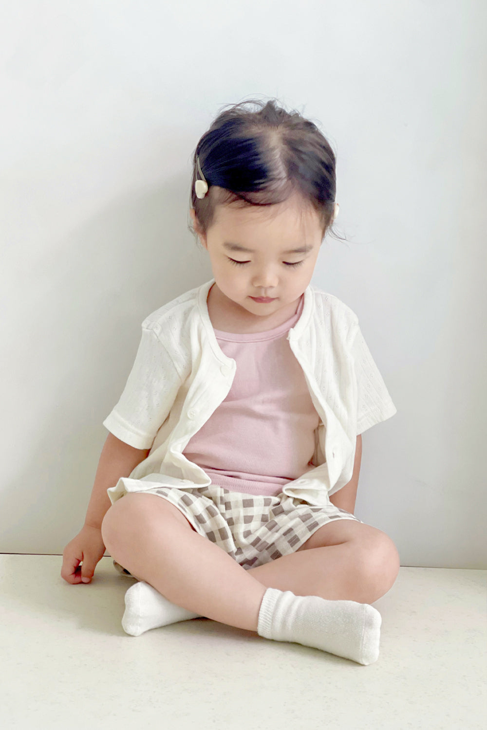 Toddler sitting in Avauma check tank top set layered with short cardigan – gentle and relaxed look
Toddler sitting in Avauma check tank top set layered with short cardigan – gentle and relaxed look
