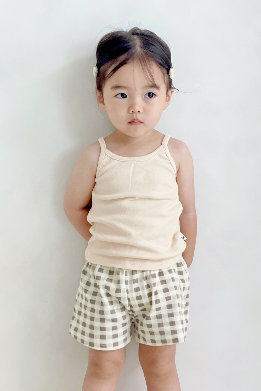 Girl wearing Avauma butter check set – sleeveless top with classic beige gingham shorts
Girl wearing Avauma butter check set – sleeveless top with classic beige gingham shorts