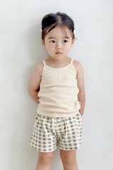 Girl wearing Avauma butter check set – sleeveless top with classic beige gingham shorts
Girl wearing Avauma butter check set – sleeveless top with classic beige gingham shorts