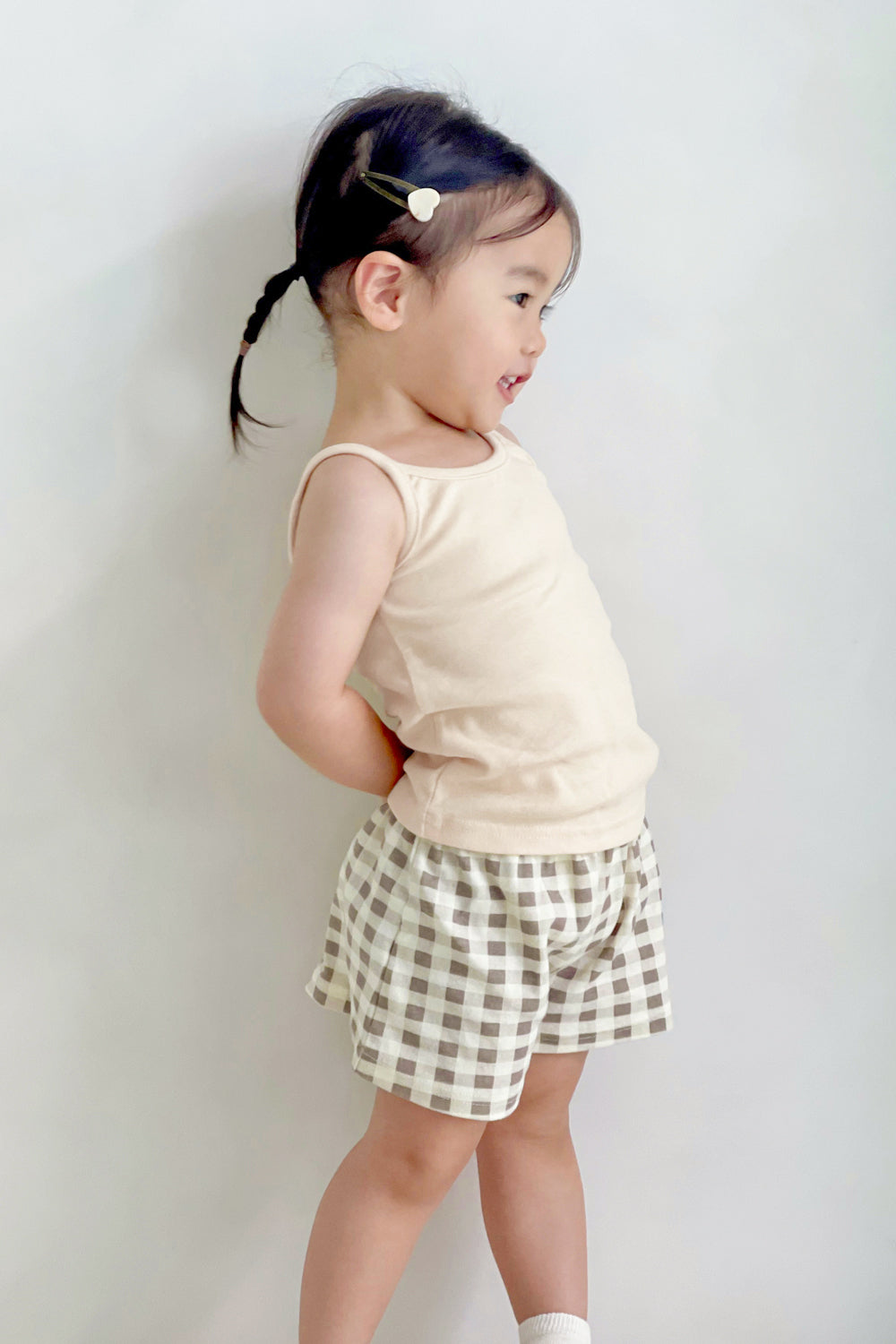 Side view of girl in Avauma butter tank top and check shorts – comfy summer dailywear
Side view of girl in Avauma butter tank top and check shorts – comfy summer dailywear