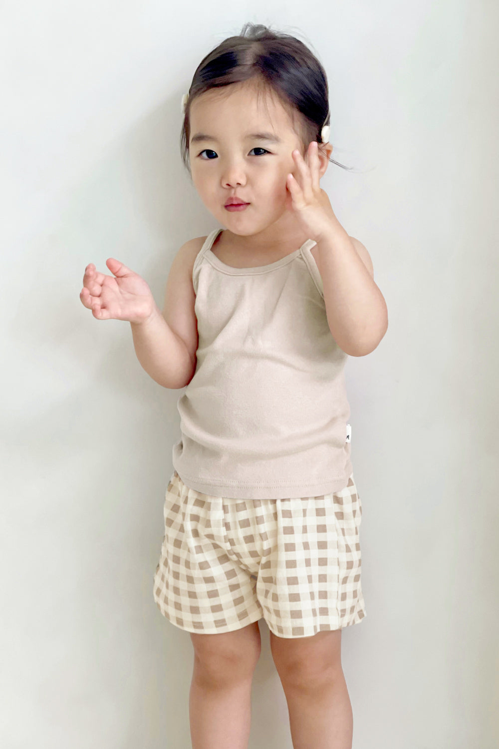 Toddler in Avauma butter tank set – light beige sleeveless top with brown gingham shorts
Toddler in Avauma butter tank set – light beige sleeveless top with brown gingham shorts