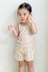 Toddler in Avauma butter tank set – light beige sleeveless top with brown gingham shorts
Toddler in Avauma butter tank set – light beige sleeveless top with brown gingham shorts
