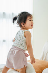 Toddler standing in Avauma blue mint garden sleeveless top and pink shorts – light and active outfit
Toddler standing in Avauma blue mint garden sleeveless top and pink shorts – light and active outfit