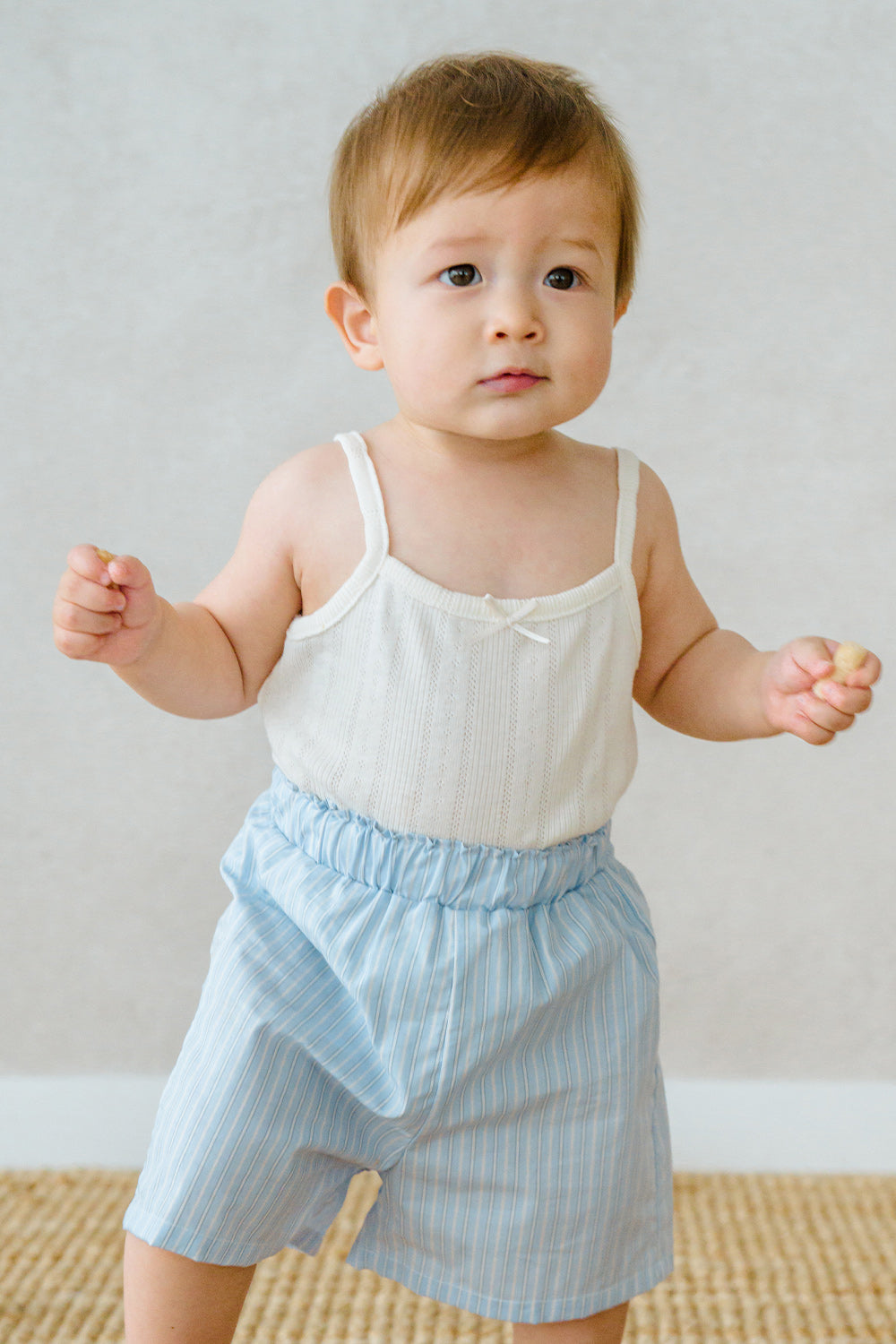 Baby wearing Avauma pure vanilla sleeveless top and blue striped shorts – fresh summer outfit
Baby wearing Avauma pure vanilla sleeveless top and blue striped shorts – fresh summer outfit