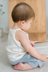 Side view of baby sitting in Avauma pure vanilla sleeveless top – relaxed and breathable fit
Side view of baby sitting in Avauma pure vanilla sleeveless top – relaxed and breathable fit