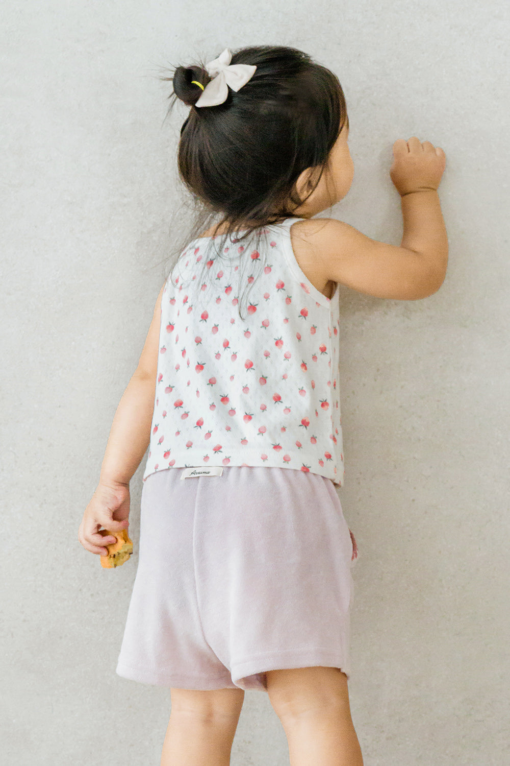 Back view of girl wearing Avauma strawberry cream sleeveless top and lavender shorts – light dailywear
Back view of girl wearing Avauma strawberry cream sleeveless top and lavender shorts – light dailywear