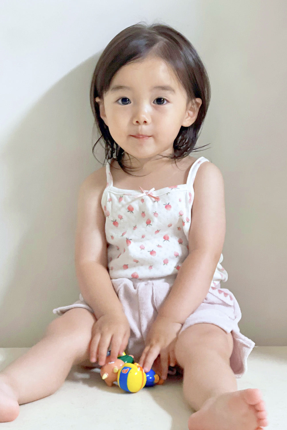 Toddler girl holding toys in Avauma strawberry cream sleeveless top and printed shorts – lively summer vibe
Toddler girl holding toys in Avauma strawberry cream sleeveless top and printed shorts – lively summer vibe