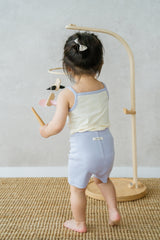 Toddler girl wearing AVAUMA Laila Day sleeveless lilac cream set, back view Toddler girl wearing AVAUMA Laila Day sleeveless lilac cream set, back view