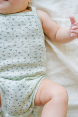 Close-up of Avauma Lily Sleeveless Bodysuit Sage Flower on baby. Infant's arm and side view showing delicate sage green floral print on the romper.
Close-up of Avauma Lily Sleeveless Bodysuit Sage Flower on baby. Infant's arm and side view showing delicate sage green floral print on the romper.