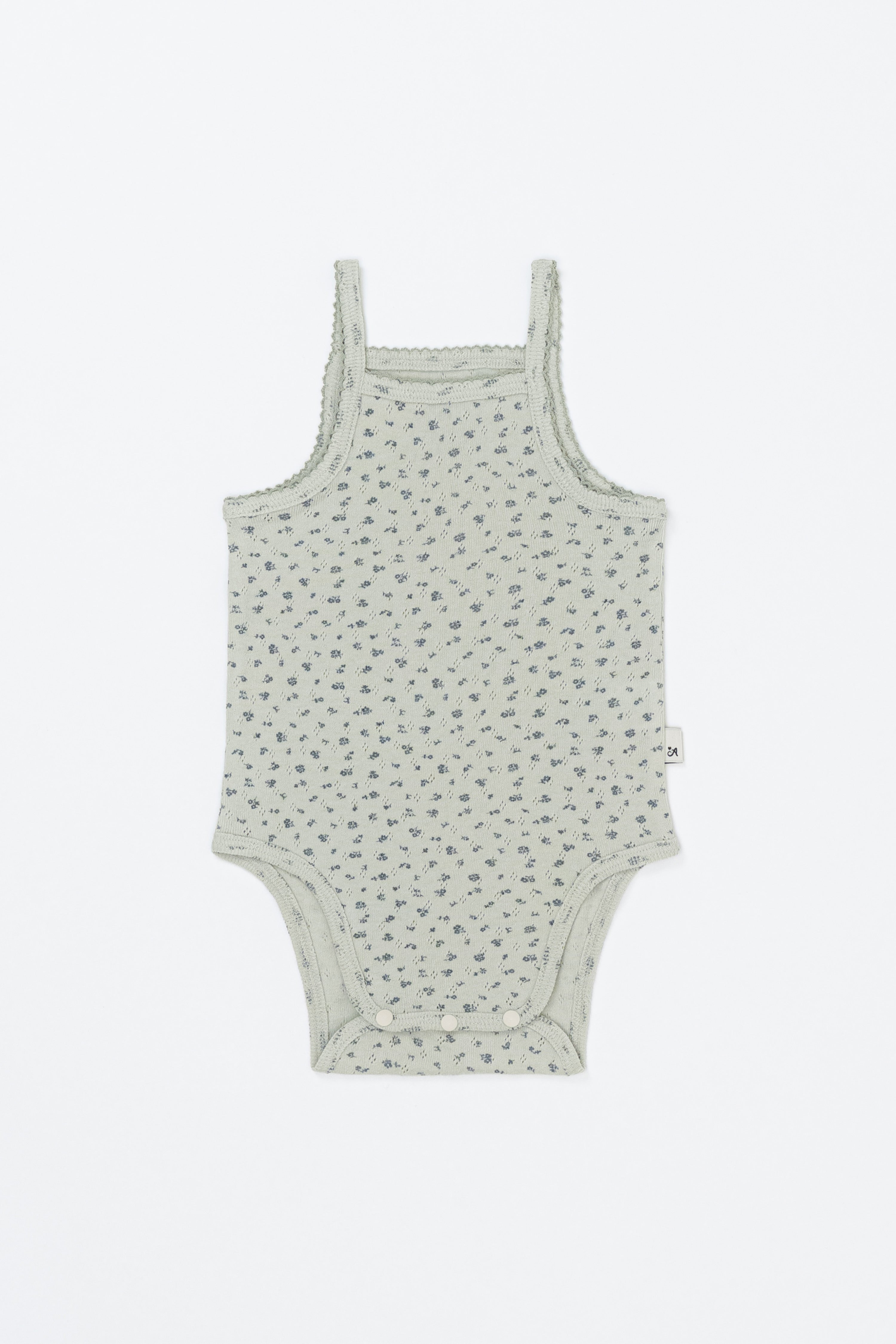 Avauma Lily Sleeveless Bodysuit Sage Flower product shot. Lay-flat of sage green baby romper with subtle floral print on a white background.
Avauma Lily Sleeveless Bodysuit Sage Flower product shot. Lay-flat of sage green baby romper with subtle floral print on a white background.