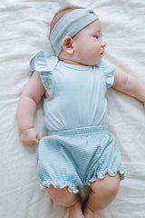 Cute baby model wearing Avauma Mellow Stripe Set Aquamint. Newborn in light blue striped outfit, comfortable baby clothes. Cute baby model wearing Avauma Mellow Stripe Set Aquamint. Newborn in light blue striped outfit, comfortable baby clothes.