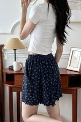 Avauma Petitbloom mom shorts in navy floral pattern, styled with white T-shirt, full-body shot.
Avauma Petitbloom mom shorts in navy floral pattern, styled with white T-shirt, full-body shot.