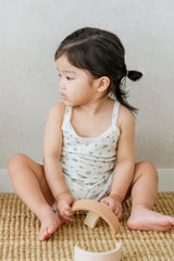 Girl toddler sitting on woven mat holding a basket in Avauma Blue Herb tank top set
Girl toddler sitting on woven mat holding a basket in Avauma Blue Herb tank top set