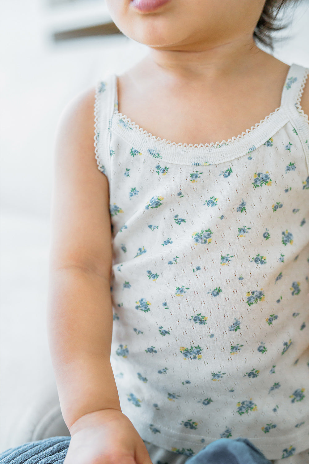 Close-up of toddler wearing Avauma Blue Herb tank top showing floral print
Close-up of toddler wearing Avauma Blue Herb tank top showing floral print