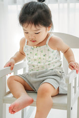 Baby boy wearing Avauma Pocket Shorts in Green Tea Milk and sleeveless top, standing by a wooden rail
Baby boy wearing Avauma Pocket Shorts in Green Tea Milk and sleeveless top, standing by a wooden rail