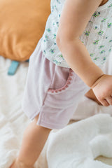 Close-up side view of Avauma Milk Pink Shorts on toddler, showing scallop-trimmed pockets
Close-up side view of Avauma Milk Pink Shorts on toddler, showing scallop-trimmed pockets