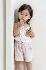 Little girl in Avauma Pocket Shorts in Milk Pink and matching floral top, standing indoors
Little girl in Avauma Pocket Shorts in Milk Pink and matching floral top, standing indoors